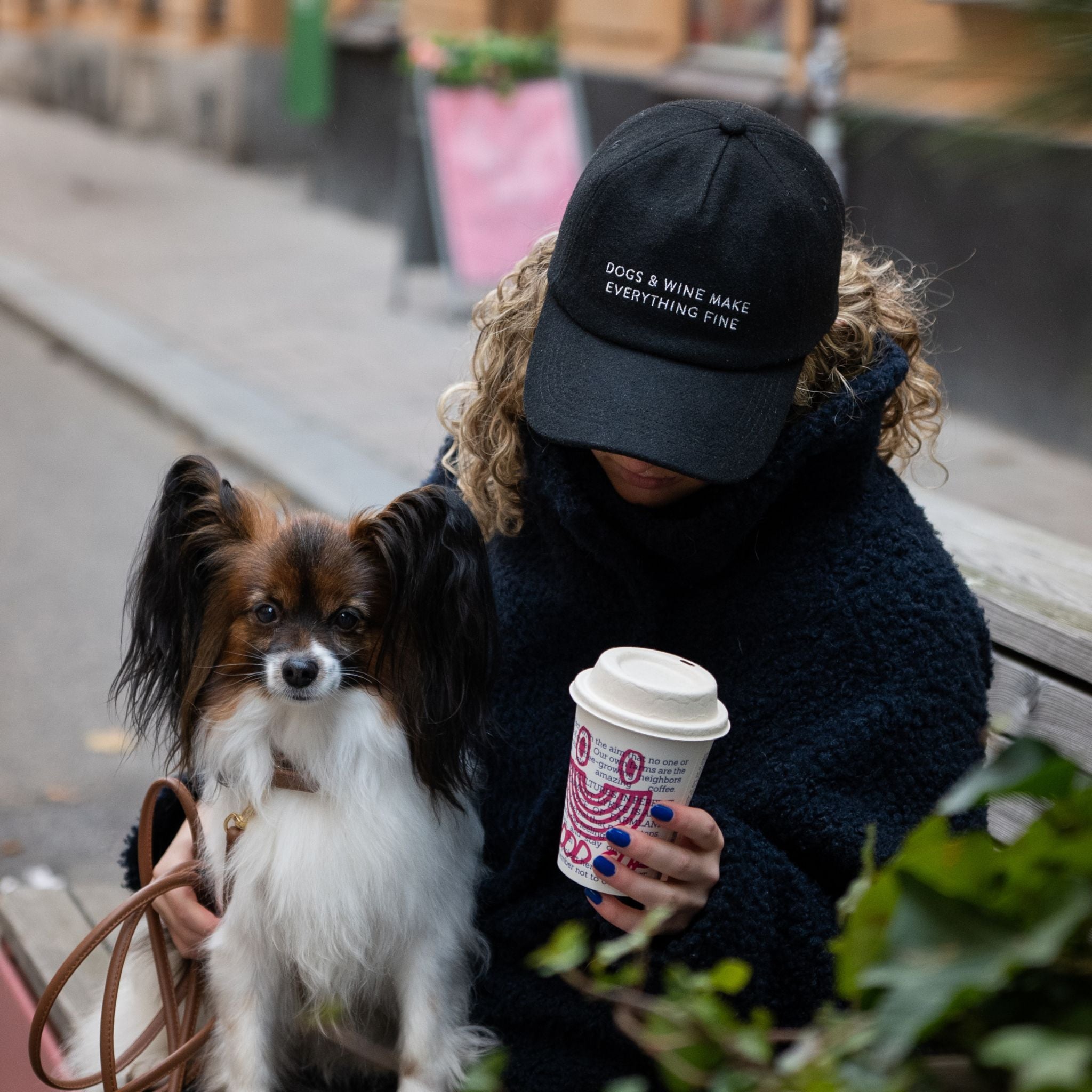 black-wool-cap-dogs-wine-wearing-woman.jpg